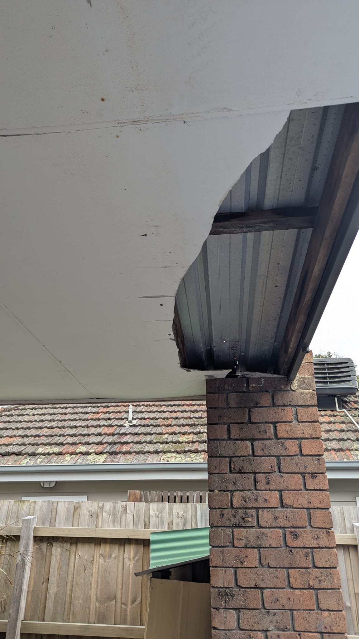 Broken cement sheeting under carport before repair North Brisbane